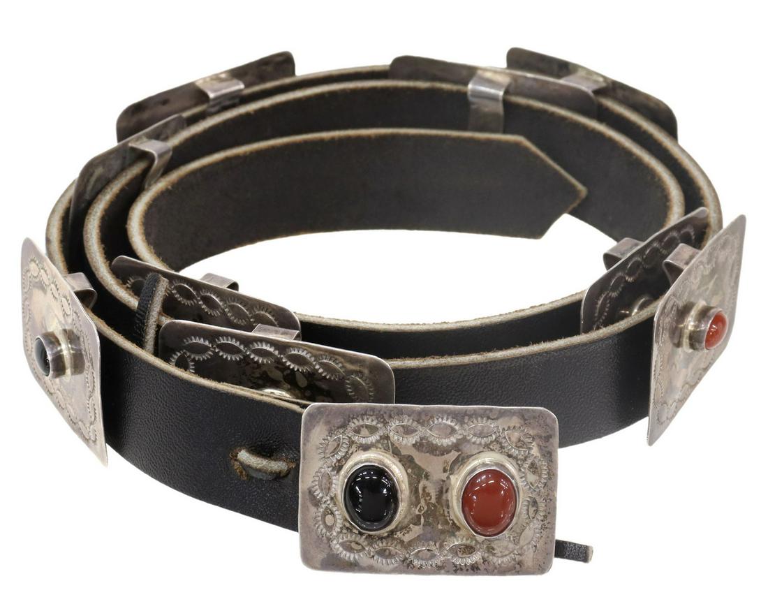 YELLOWHORSE NAVAJO SILVER CHILD'S CONCHO BELT: Native American silver (content unknown) child's concho belt/ hat band, signed B. Yellowhorse (Navajo/ Dine), nine conchos and belt buckle, with stamped designs, black and red cabochons, on a black le
