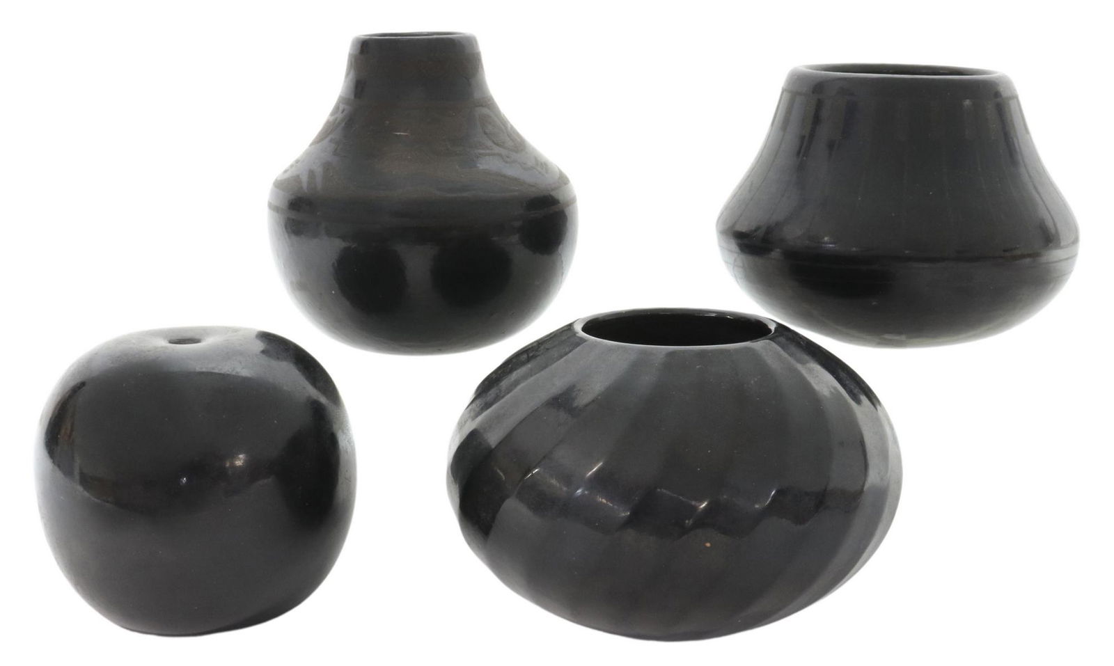 (4) SANTA CLARA & SAN ILDEFONSO PUEBLO POTTERY: (lot of 4) Native American black-on-black ware, New Mexico, including: (1) seed jar, Cookie Tafoya (Santa Clara Pueblo), burnished surface, approx 3 3/8"h, 3.75"diam, (1) small jar, Jerry Sisneros (Sa