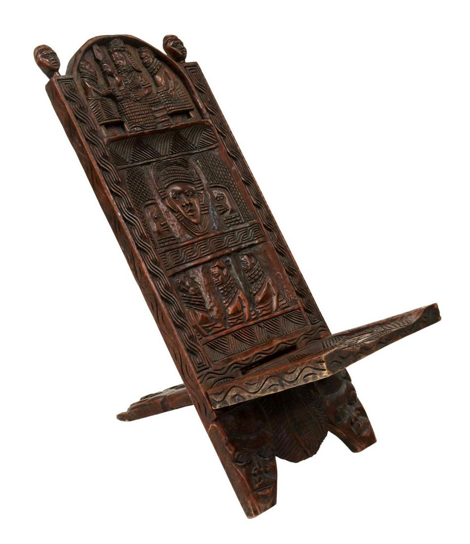 AFRICAN TRIBAL CARVED HARDWOOD PALAVER CHAIR: African carved hardwood palaver chair, likely Edo/ Benin peoples, Nigeria, comprised of two interlocking planks, carved with figural reserves, geometric patterns, approx 40.5"h, 20.25"w, 34"d Start Pr