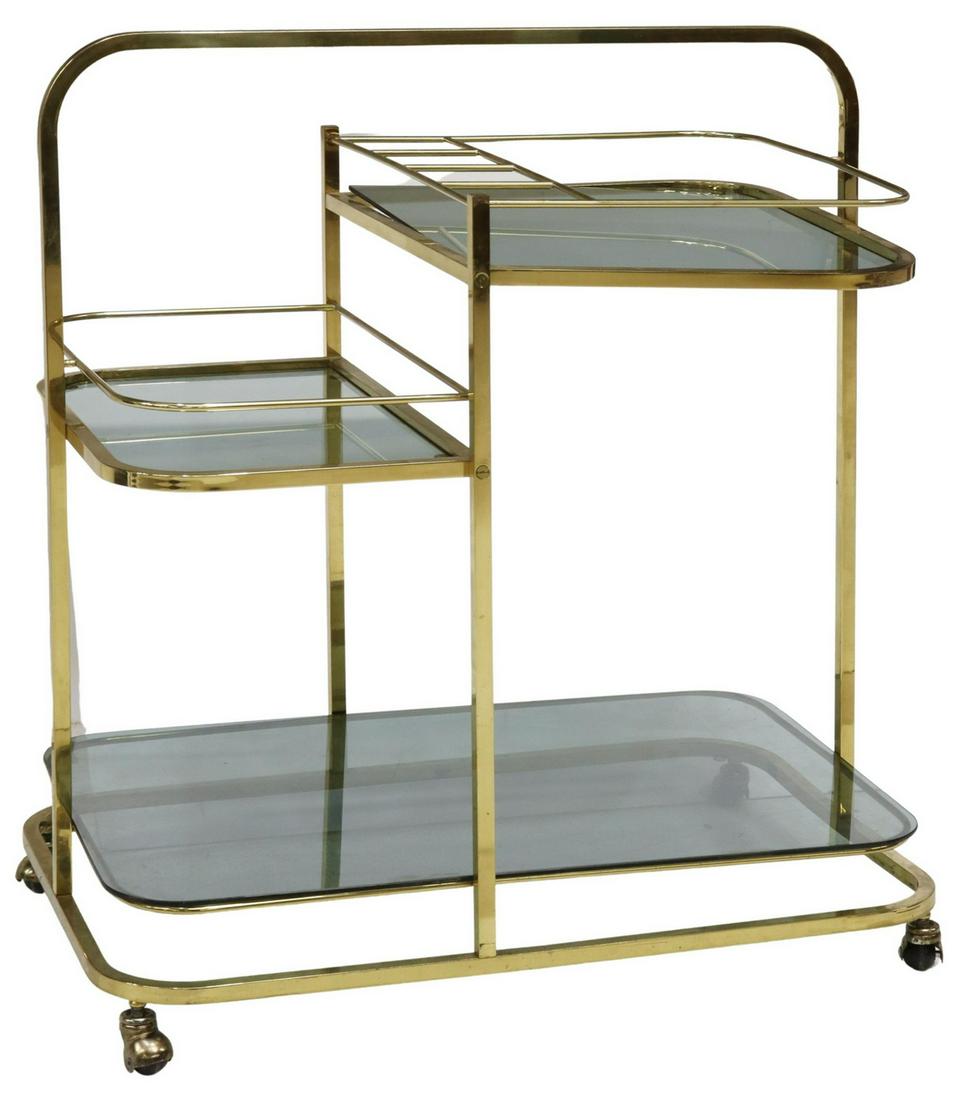 MID-CENTURY MODERN SMOKED GLASS BAR CART: Mid-century modern service trolley/ bar cart, c.1960s, gilt metal frame, three smoked glass tiers, on casters, approx 32.5"h, 29.75"w, 19.5"d Start Price: $150.00