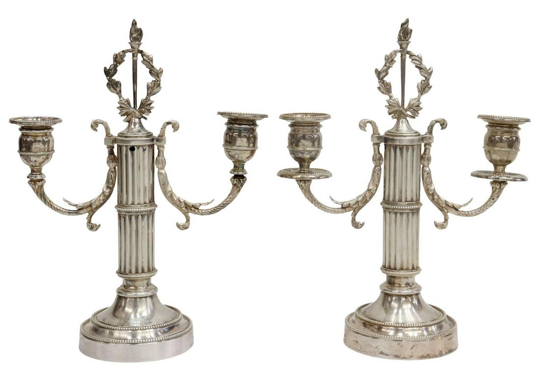 (2) FRENCH LOUIS XVI STYLE SILVERPLATE CANDELABRA: (pair) French Louis XVI style silverplate candelabra, having ribbed column-form standard, topped with torch and laurel wreath, issuing two foliate scroll arms, ending in candle cups, rising on round b