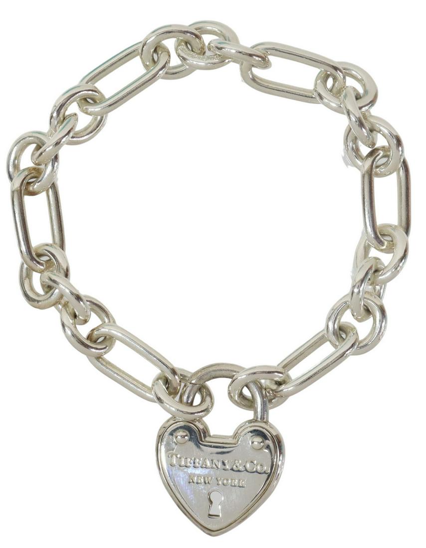 TIFFANY & CO. STERLING HEART ARC PADLOCK BRACELET: Tiffany & Company sterling silver heart arc padlock bracelet, having oval and round links, chain and charm marked AG 925, retaining branded pouch and box, 1.30ozt (weighable silver only) Start Price: 
