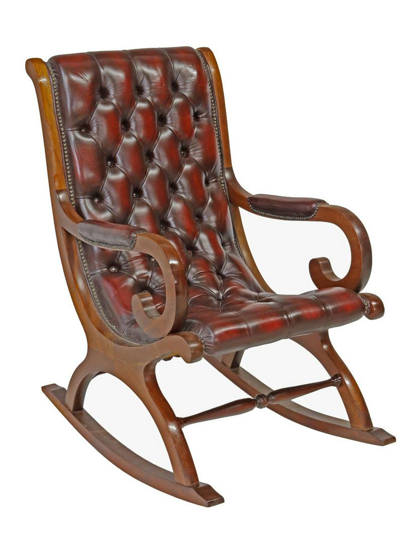 CAMPECHE STYLE TUFTED LEATHER ROCKING CHAIR: Campeche style rocking chair, late 20th c., mahogany frame, oxblood leather upholstery, button-tufted back and seat, brass tack trim, scrolled arms, x-form base joined by turned stretchers, on rocker 