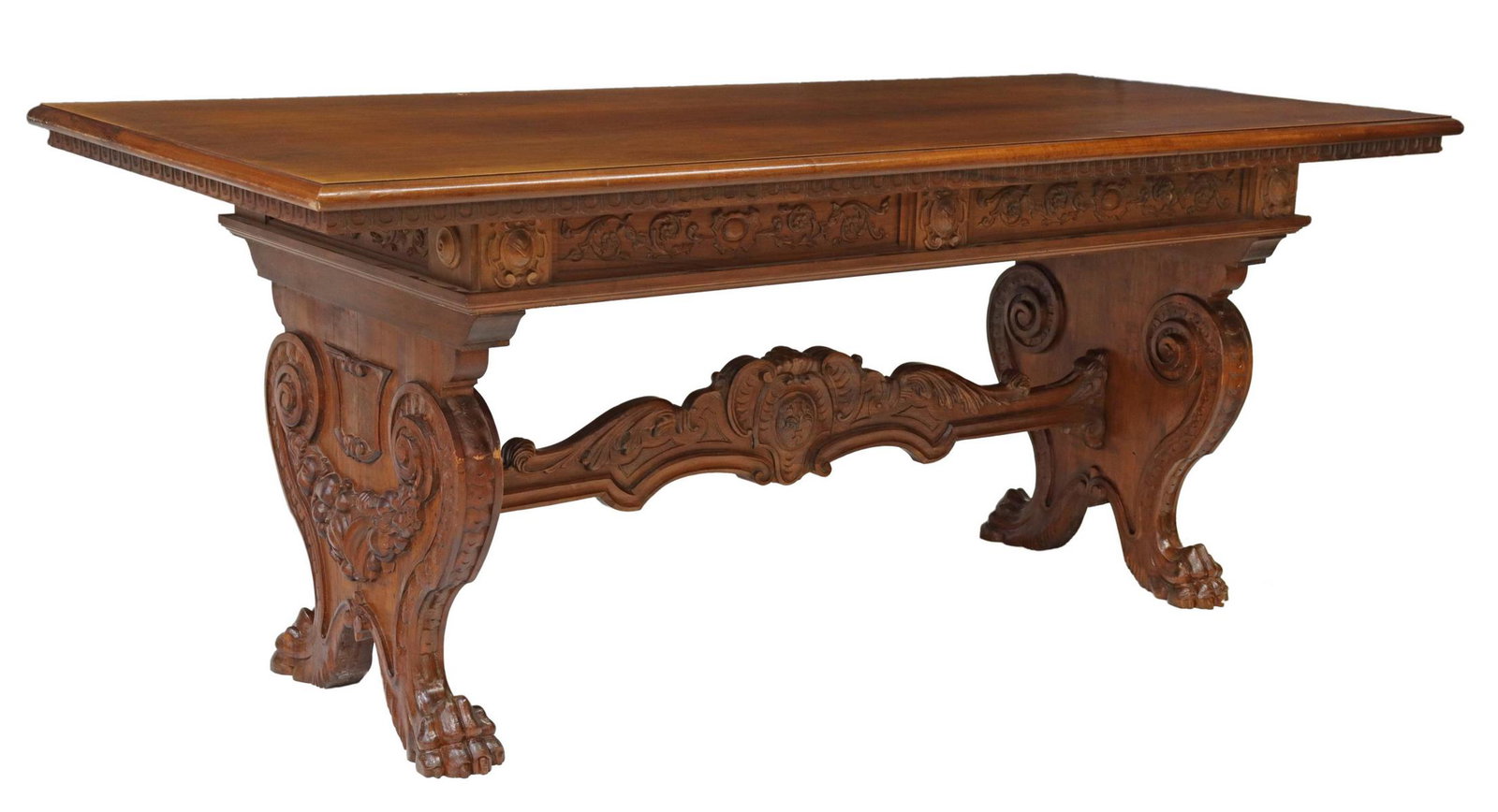 ITALIAN RENAISSANCE REVIVAL CARVED WALNUT TABLE: Italian Renaissance Revival walnut table, early 20th c., rectangular top with molded edge, over carved apron, scrolled supports with fruit festoons, joined by cross stretcher, ending in paw feet, appr