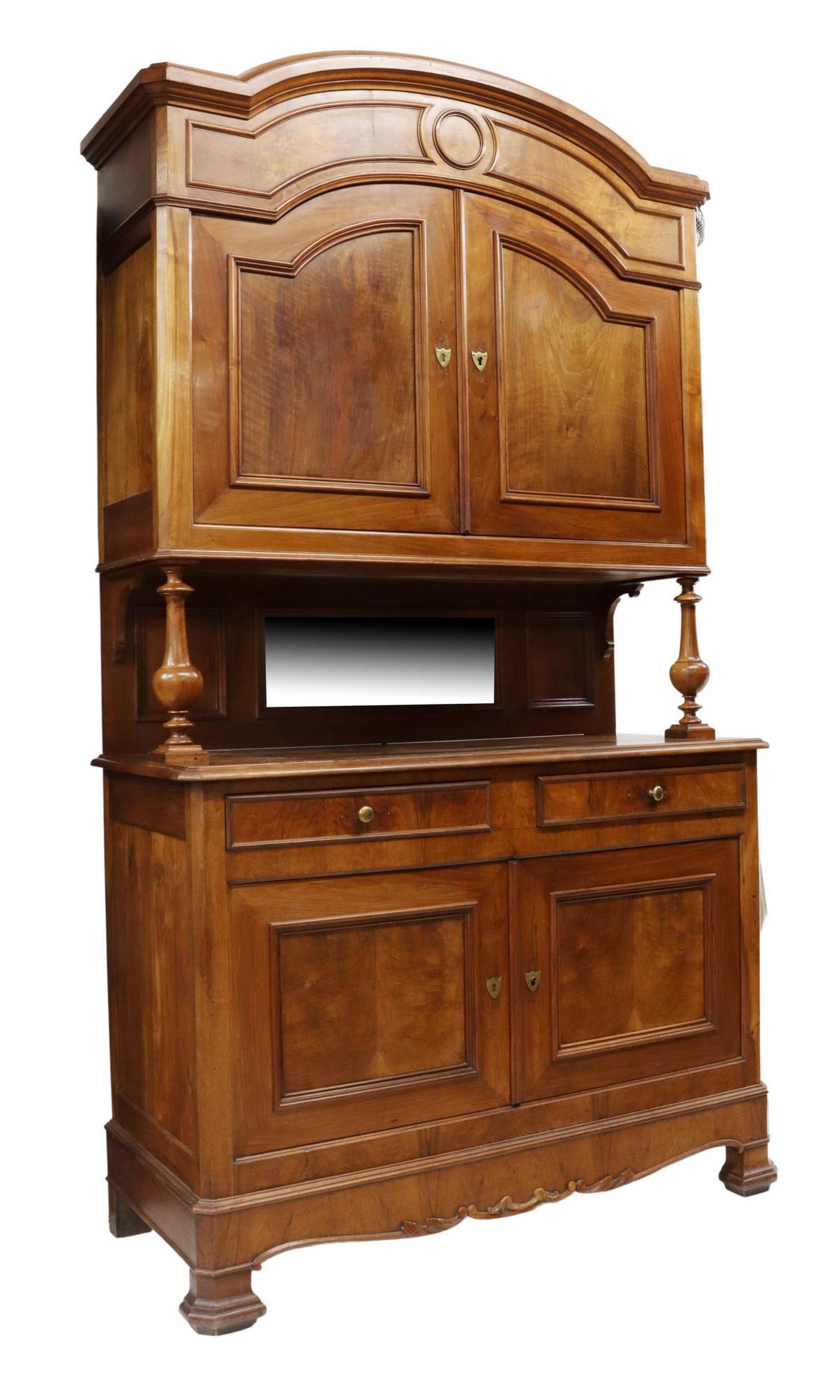 FRENCH LOUIS PHILIPPE STYLE WALNUT SIDEBOARD: French Louis Philippe style walnut sideboard, late 19th/ early 20th c., having arched cornice top, over two molded cabinet doors, lacking shelves, on turned column supports, beveled mirrored backsplas