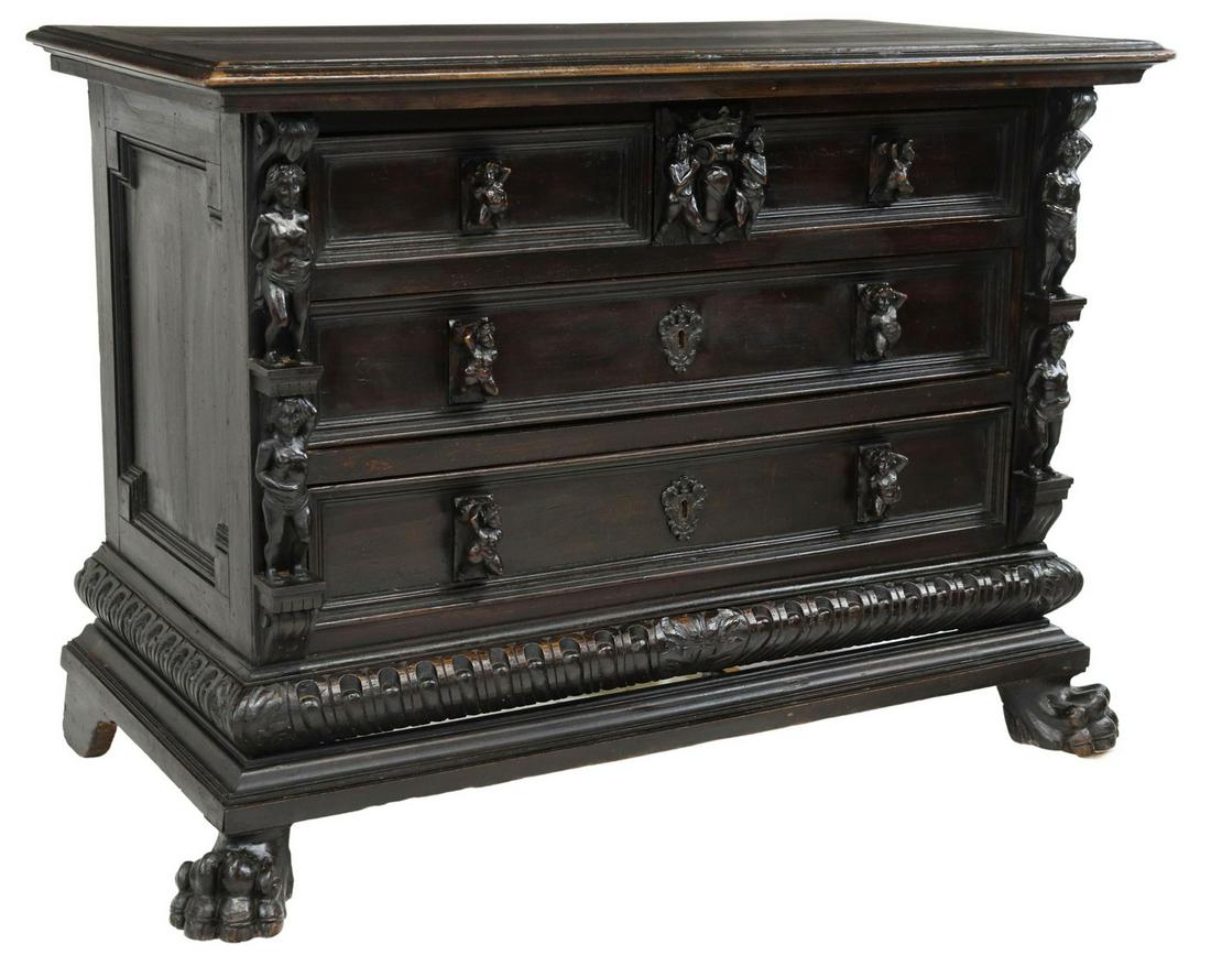 ITALIAN RENAISSANCE REVIVAL EBONIZED COMMODE: Italian Renaissance Revival ebonized commode, 19th c., five drawers, with figural carved pulls, flanked by carved putti, base with gadrooned molding, rising on front paw feet, approx 37.75"h, 54"w, 26