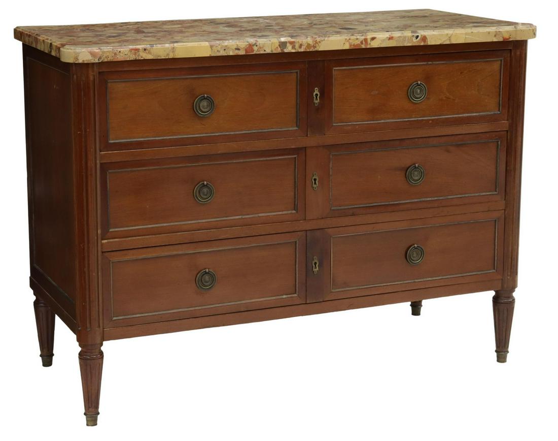 FRENCH LOUIS XVI STYLE MARBLE-TOP MAHOGANY COMMODE: French Louis XVI style mahogany commode, early 20th c., having shaped marble top, over three drawers, accented with patinated gilt metal ring pulls, molding and escutcheons, rising on fluted tapered l