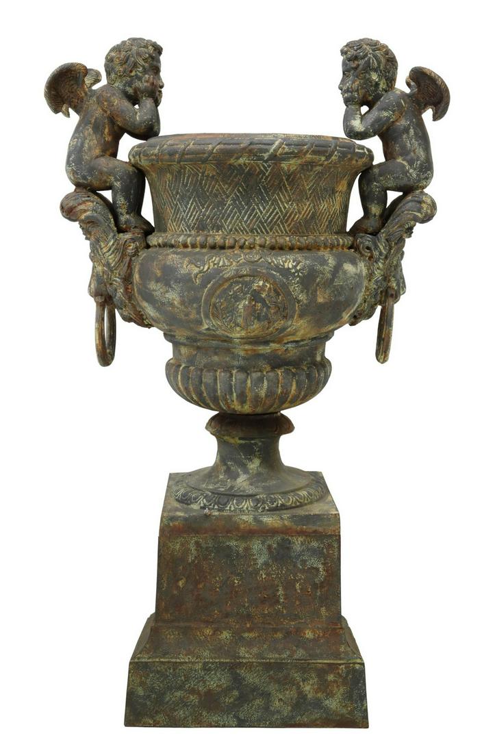 CAST IRON VERSAILLES STYLE GARDEN URN PLANTER, 55"H: Large cast iron garden urn/ planter, after the example designed by Claude Ballin the Elder (French, 1615-1678) for the gardens of Versailles, 20th c., winged putti seated above the lion's mask and rin