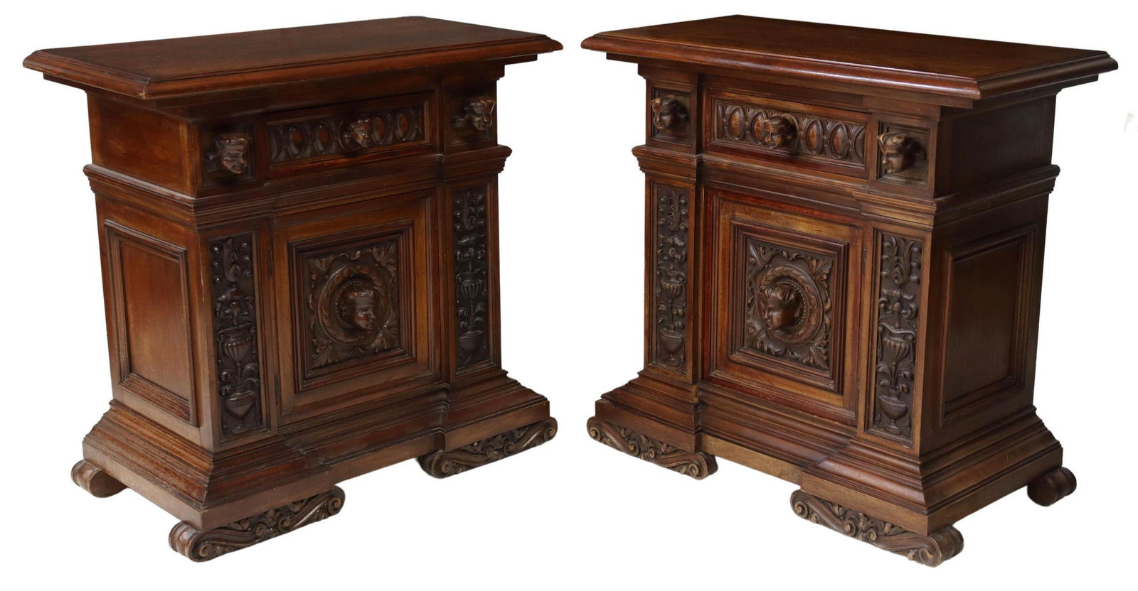 (2) ITALIAN RENAISSANCE REVIVAL WALNUT NIGHTSTANDS: (pair) Italian Renaissance Revival walnut bedside cabinets, Carlo Puccini, early 20th c., single drawer over cabinet door, with projecting putti masks, carved foliage and urns, stepped molded base, ri