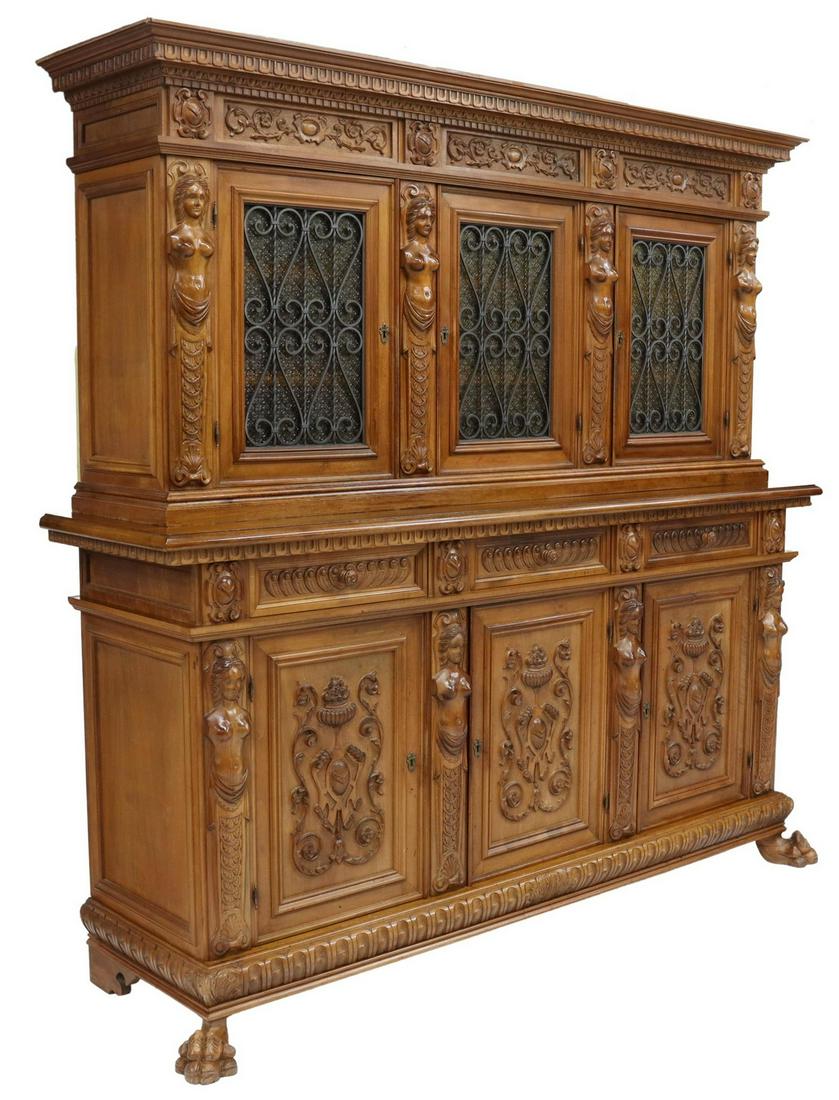 ITALIAN RENAISSANCE STYLE CARVED WALNUT SIDEBOARD: Italian Renaissance style carved walnut sideboard, late 20th c., stepback upper cabinet with three doors, wrought iron and glass panels, lower case fitted with three drawers, over three cabinet doors,