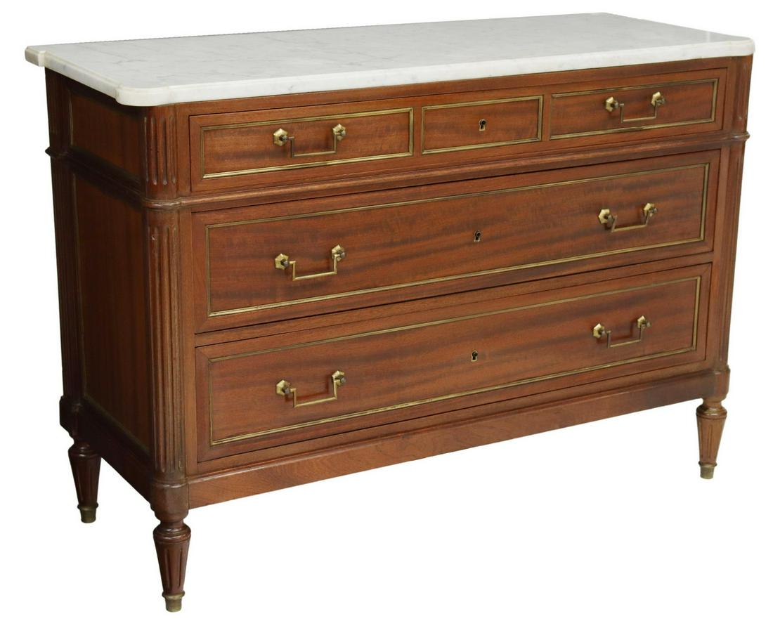 FRENCH LOUIS XVI STYLE MARBLE-TOP MAHOGANY COMMODE: French Louis XVI style mahogany commode, early 20th c., having shaped marble top with cup corners, over conforming case, fitted with three drawers, accented with metal pulls and trim, fluted corner po