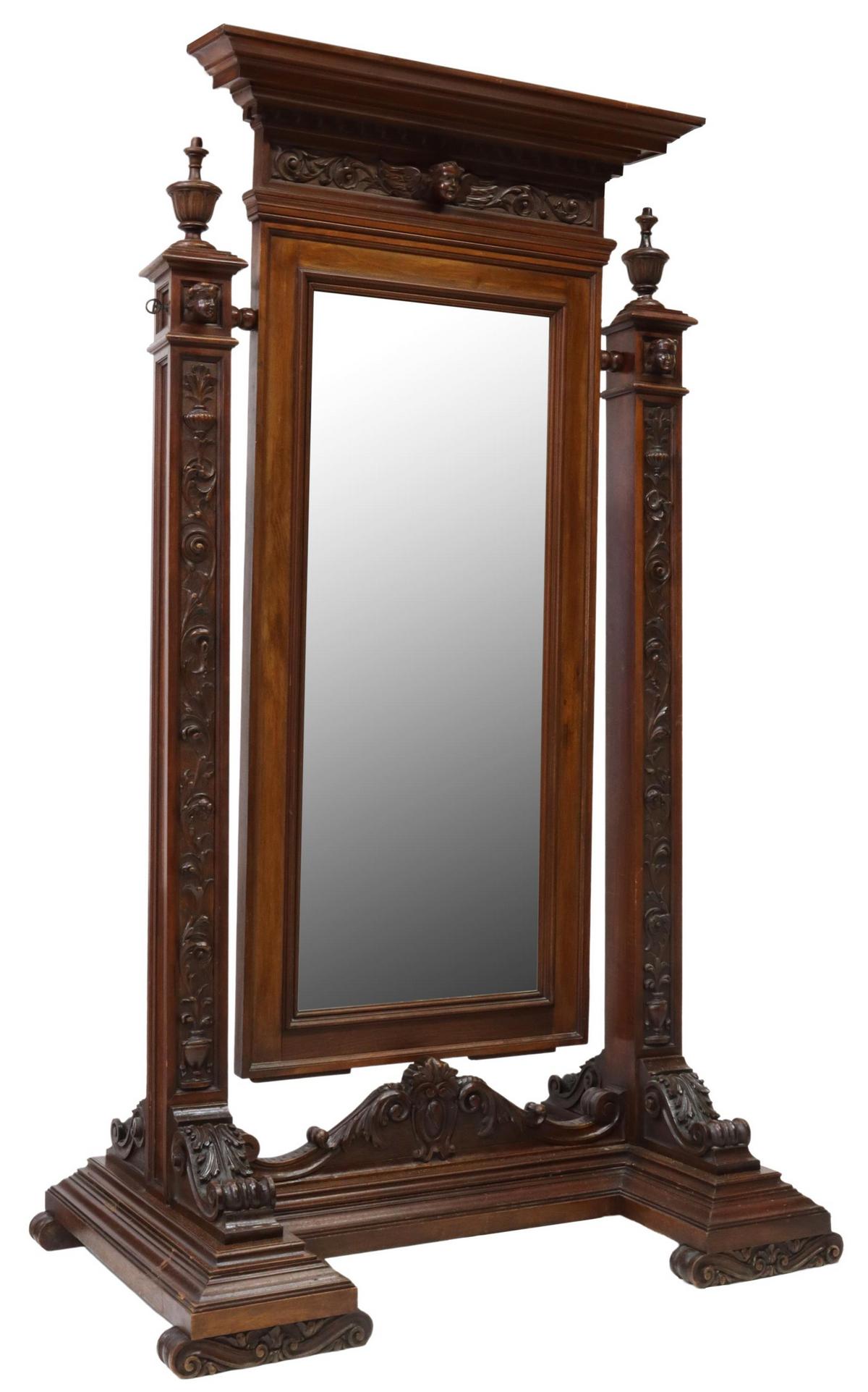ITALIAN RENAISSANCE REVIVAL WALNUT CHEVAL MIRROR: Italian Renaissance Revival walnut cheval mirror, early 20th c., dentil molded cornice, frieze with carved winged putto mask, framed flat mirror plate, flanked by urn-form finials, over stiles with fo