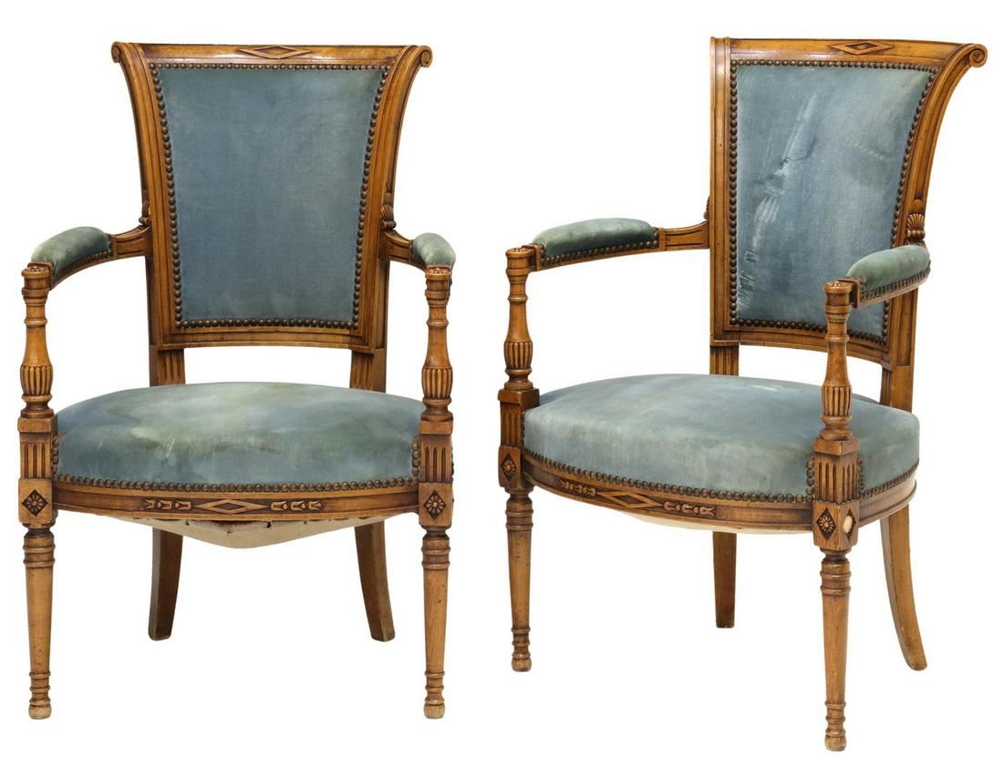 (2) FRENCH LOUIS XVI STYLE UPHOLSTERED FAUTEUILS: (pair) French Louis XVI style armchairs, 20th c., frame in a fruitwood finish, light blue velvet upholstery, with tack trim, rising on tapered legs, staining to upholstery, approx 34.5"h, 22.5"w, 18.5