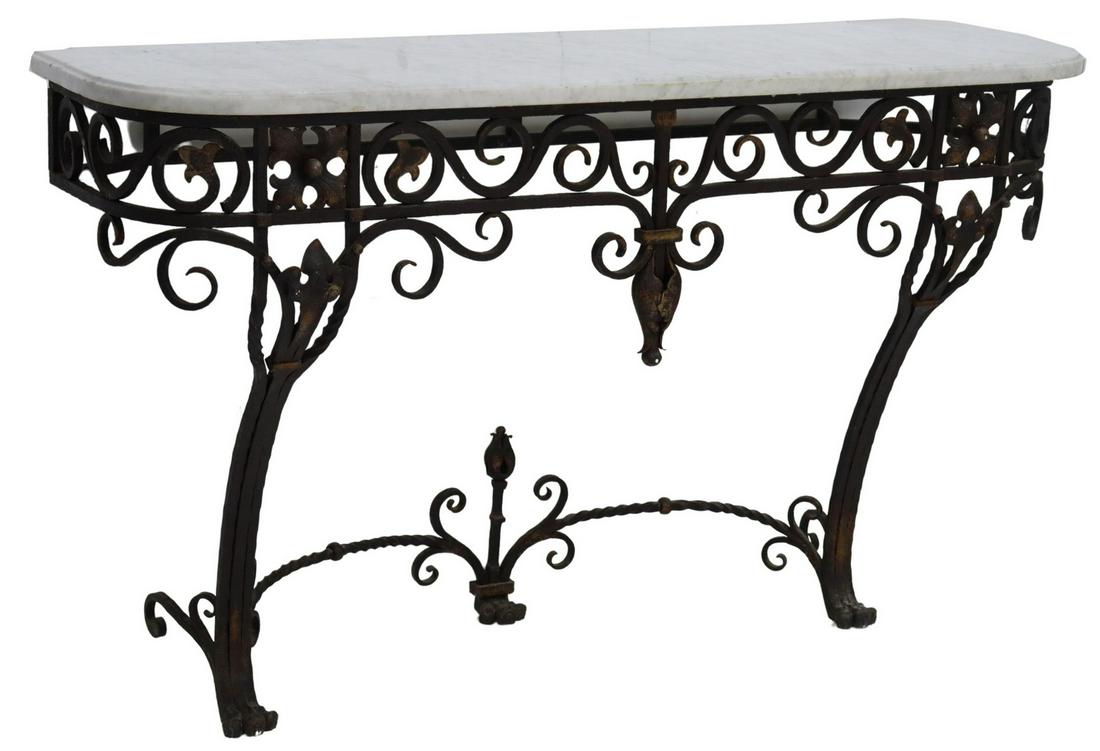 FRENCH MARBLE-TOP WROUGHT IRON CONSOLE TABLE: French wall-mounted console table, early 20th c., shaped marble top, wrought iron frame with scrolls, stylized foliage, fleur-de-lis, etc., front supports joined by cross stretcher, ending in paw feet