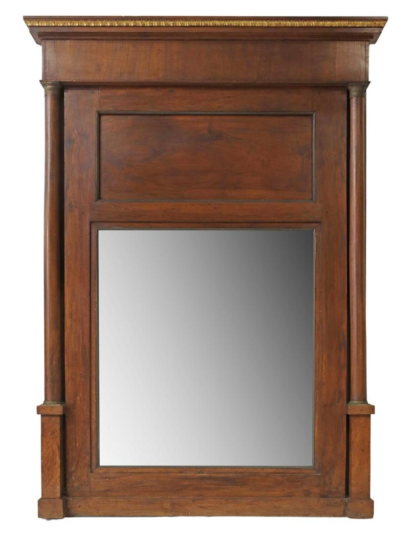 FRENCH EMPIRE MAHOGANY PIER MIRROR: French Empire mahogany pier mirror, 19th c., parcel gilt molded cornice, full-turned columns flanking the flat mirror plate, stepped feet, losses to mirror silvering, approx 71"h, 47.75"w Start Price: