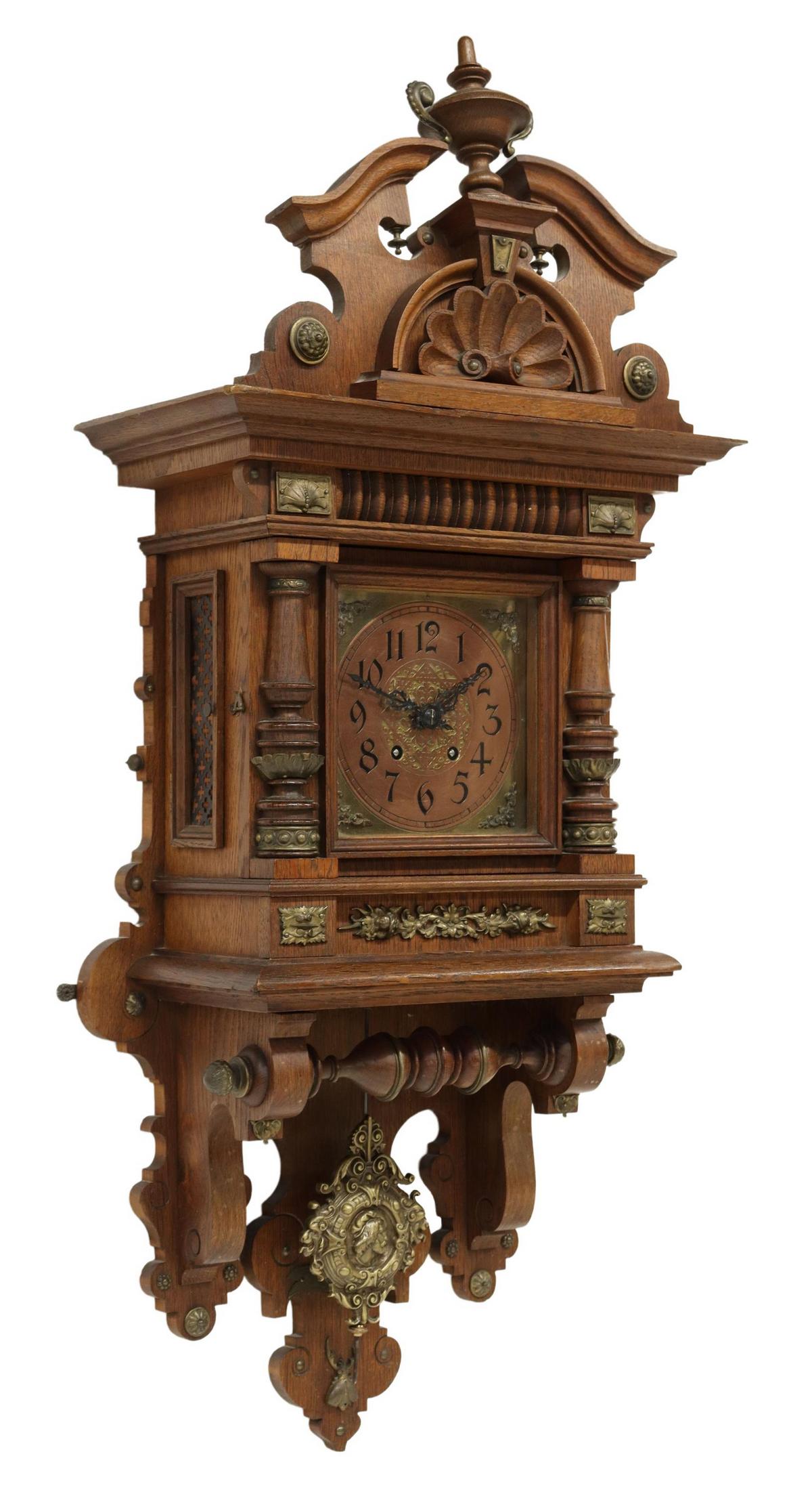 GERMAN LENZKIRCH CARVED OAK WALL CLOCK: German fancy carved oak wall clock, Lenzkirch, late 19th/ early 20th c., topped with split pediment and urn crest, over molded cornice and frieze, accented with gilt metal mounts and German inscriptio