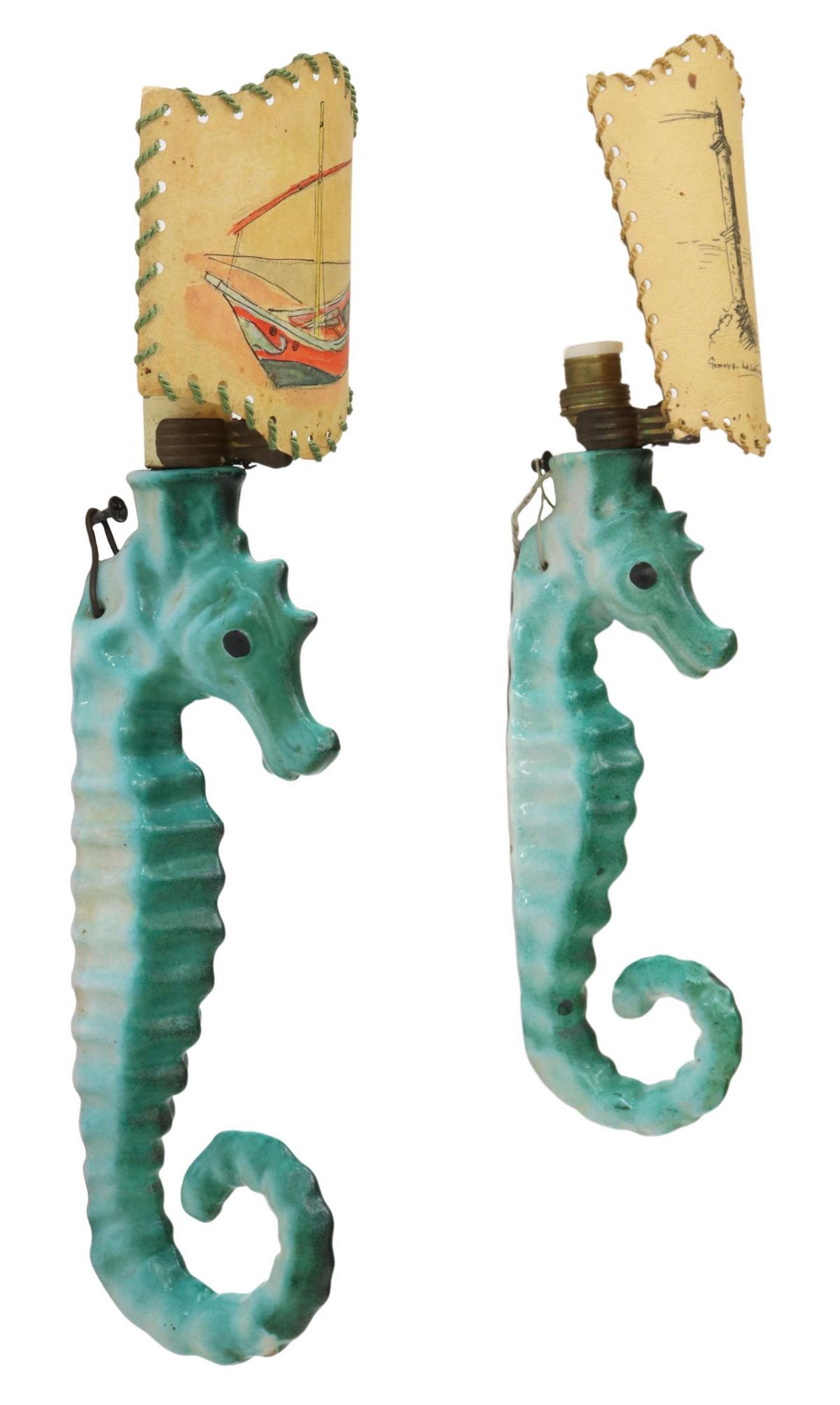 (2) ITALIAN CERAMIC SEAHORSE 1-LIGHT WALL SCONCES: (pair) Italian mid-century modern ceramic seahorse sconces, c.1950s, varied sizes and shades, decorated in polychrome enamel, topped with hand-illustrated paper shade, concealing single light fixture,