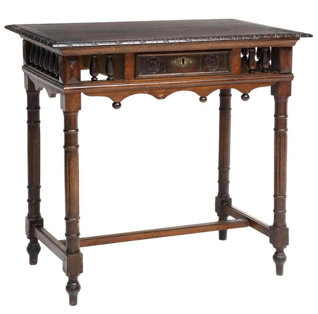 FRENCH CARVED MAHOGANY WRITING TABLE: French mahogany writing table, 19th c., rectangular top with carved edge, over arch and spindle apron, fitted with single drawer, accented with ball terminals, gilt metal escutcheon, rising on fluted 