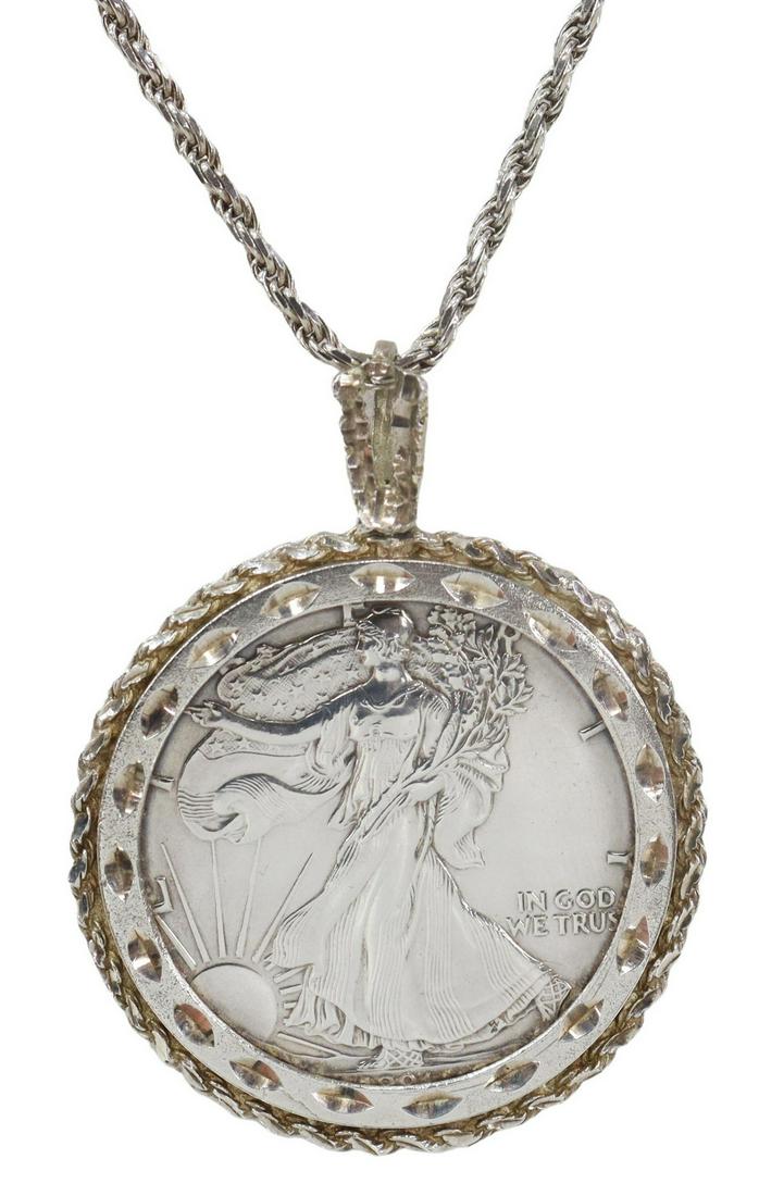 FINE SILVER AMERICAN EAGLE COIN PENDANT NECKLACE: Sterling silver pendant necklace, American Eagle 1 oz fine silver one dollar coin, in rope twist setting, on an Italian sterling silver rope chain, pendant: approx 2 3/8"h, 1 7/8"w (measurements inclu