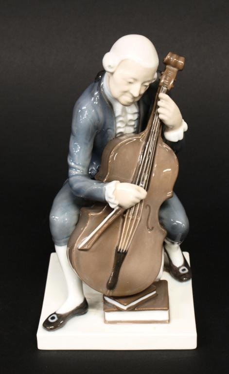 BING & GRONDAHL PORCELAIN FIGURE, CELLIST 2032: Bing & Grondahl, Denmark porcelain figure modeled as a man in 18th c. dress playing the cello, numbered 2032 underfoot, examination under blacklight showing no loss, 8.75"h, 4.5"w, 1.5lbs