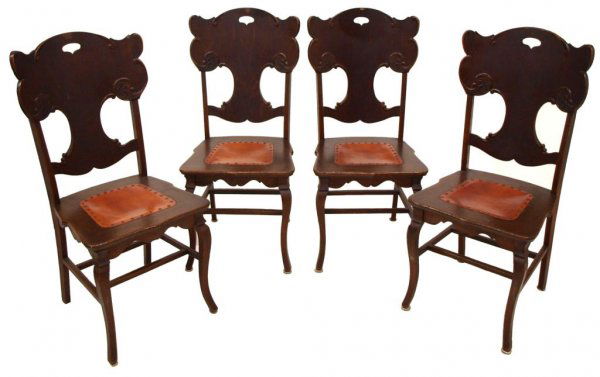 ANTIQUE AMERICAN TIGER OAK SIDE CHAIRS: American oak side chairs, c. 1900, each with curving back rest, seats centering leather affixed with small brass tacks, rising on four legs joined by stretchers, some losses with age, 40"h, 18"w, 17"d