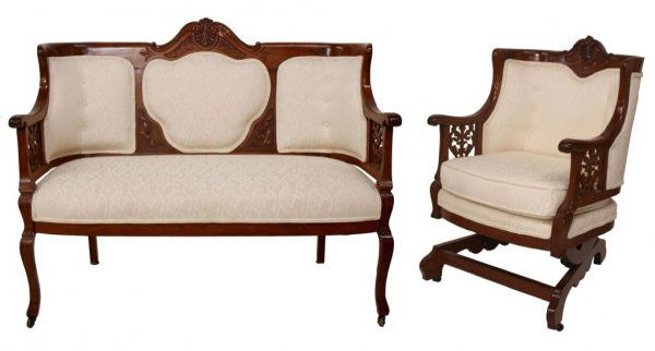AMERICAN MAHOGANY PIERCE CARVED PARLOR SUITE: (set of 2) American mahogany parlor suite comprising a settee and platform rocker, each having curved crest rail with central carving, later brocade cream on cream upholstery enclosed by pierced and c