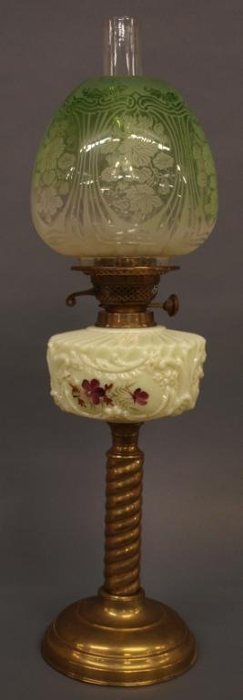 FINE VICTORIAN KEROSENE HAND PAINTED BANQUET LAMP: Victorian kerosene banquet lamp, late 19th c., the custard glass font decorated with hand painted floral reserves, brass standard on a stepped pedestal foot, the ornate acid etched shade fading from g