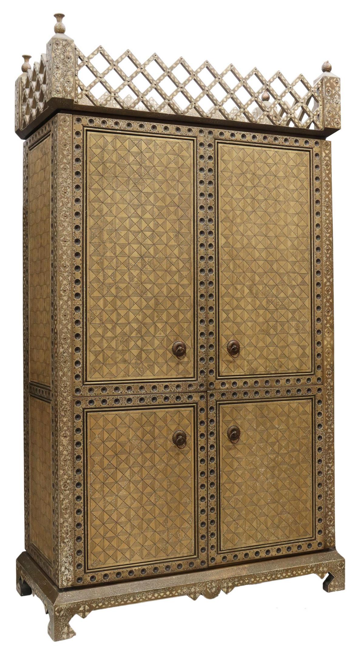 DECORATOR ENTERTAINMENT CABINET/ ARMOIRE: Decorator entertainment cabinet/ television armoire, late 20th c., lattice crest with finials at the four corners, incised geometric pattern, brass studs, two sets of double-door cabinets, opening to