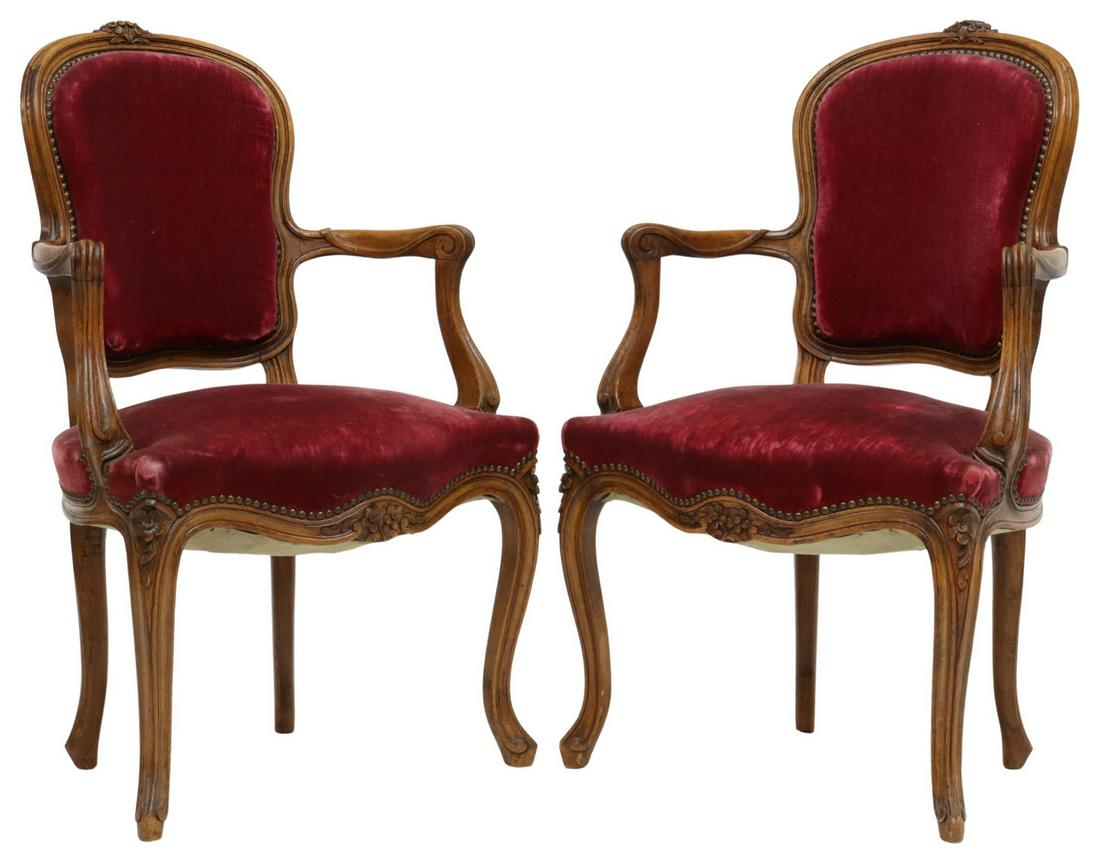(2) FRENCH LOUIS XV STYLE RED VELVET FAUTEUILS: (lot of 2) French Louis XV style armchairs, 20th c., floral carved beechwood frame, upholstered in burgundy velvet, accented by nailhead trim, rising on cabriole legs, ending in scroll feet, approx 36