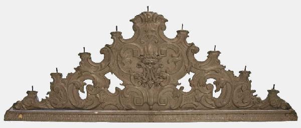 ANTIQUE WOOD & TIN ALTAR ELEMENT, MEXICO: Antique polychrome wood altar element, Mexico, 19th c., faced with tin repousse formed foliate decoration, with crown over monogram at center, top vertical screws that likely held candle receptacles, 