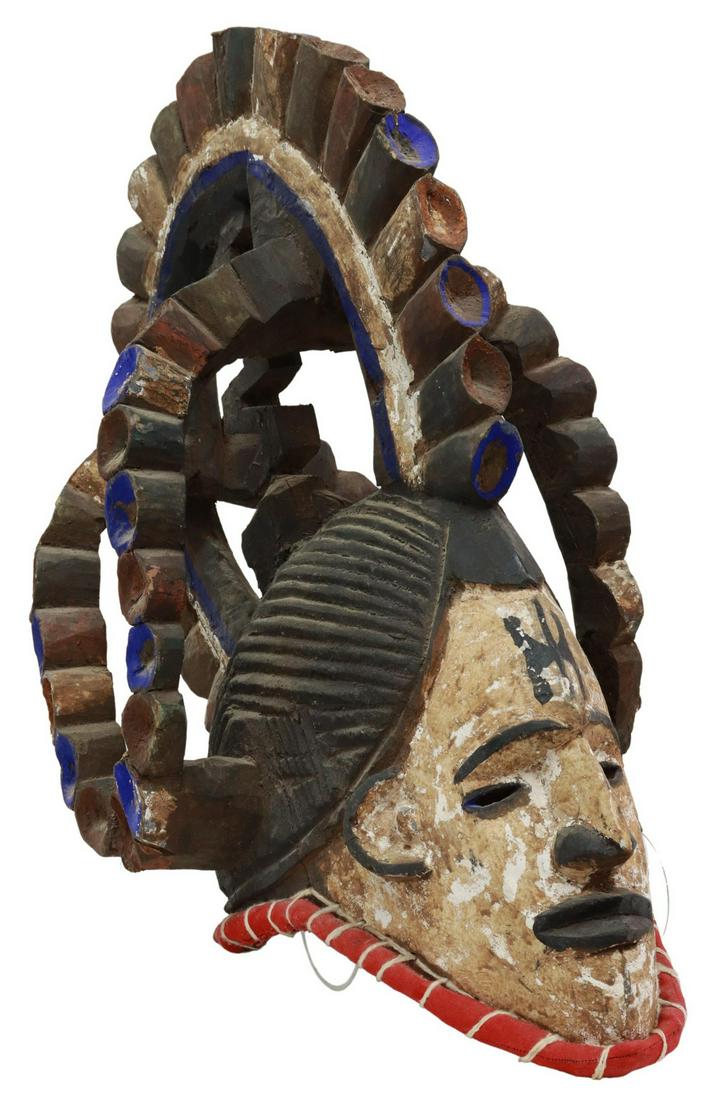 AFRICAN IGBO PEOPLES MAIDEN SPIRIT HELMET MASK: African carved wood helmet mask, Igbo Peoples, Nigeria, Agbogho Mmwo (Maiden Spirit) form, having elaborately carved hairstyle, face with white pigment representing the afterlife, scarification symbol
