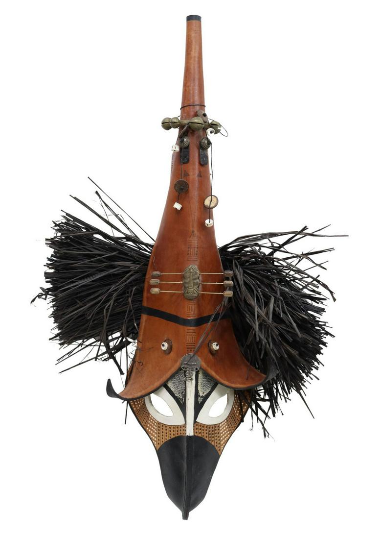 ZEKE & MARTY LEATHER ART MASK, 'TOTEM RAVEN': Leather art mask, "Totem Raven," signed Zeke and Marty Zewick, Edom, Texas, with applied brass and natural elements, approx 32.25"l, 2lbs Start Price: $80.00