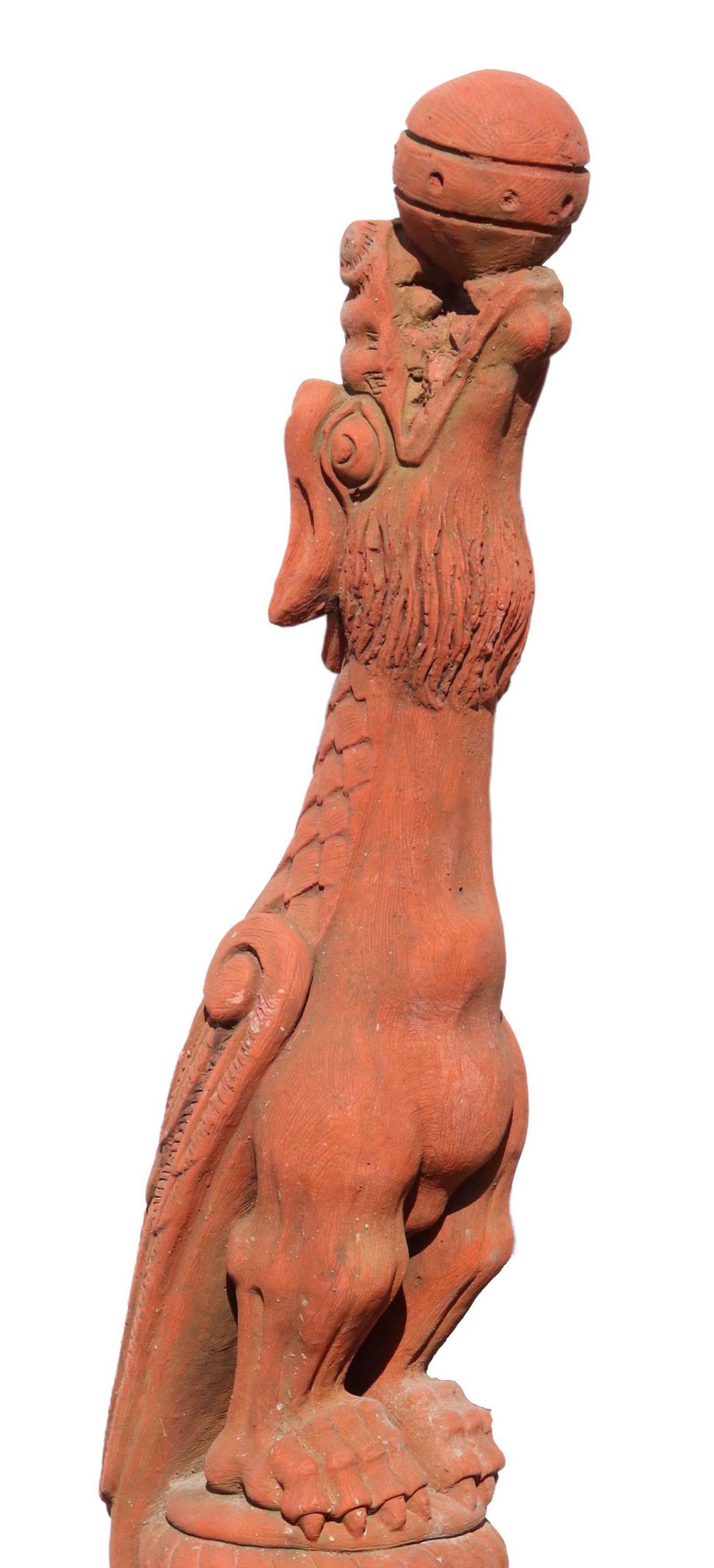 ENGLISH TERRACOTTA WYVERN ARCHITECTURAL, 46"H: English terracotta roof finial/ architectural element, 20th c., modeled as a wyvern, open mouth clutching an orb, detailed wings, long tail encircling the base, loss at lower front base, chipping, app