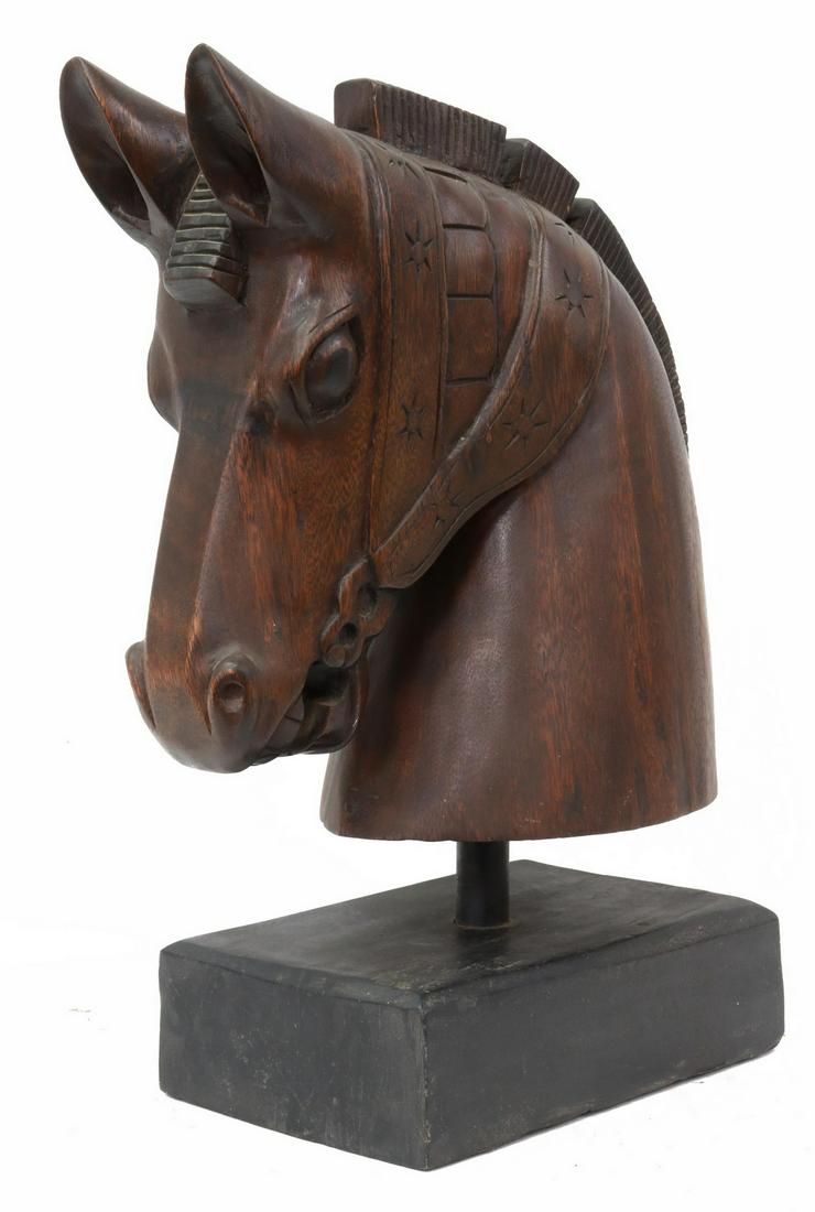 CARVED WOOD HORSE HEAD SCULPTURE, 22.5"H: Carved wood sculpture, Horse Head, with roached mane, detailed bridle, on an ebonized wood plinth, approx 22.5"h, 15"w, 8"d, 25lbs **Provenance: from the collection of writer, magazine publisher, dire