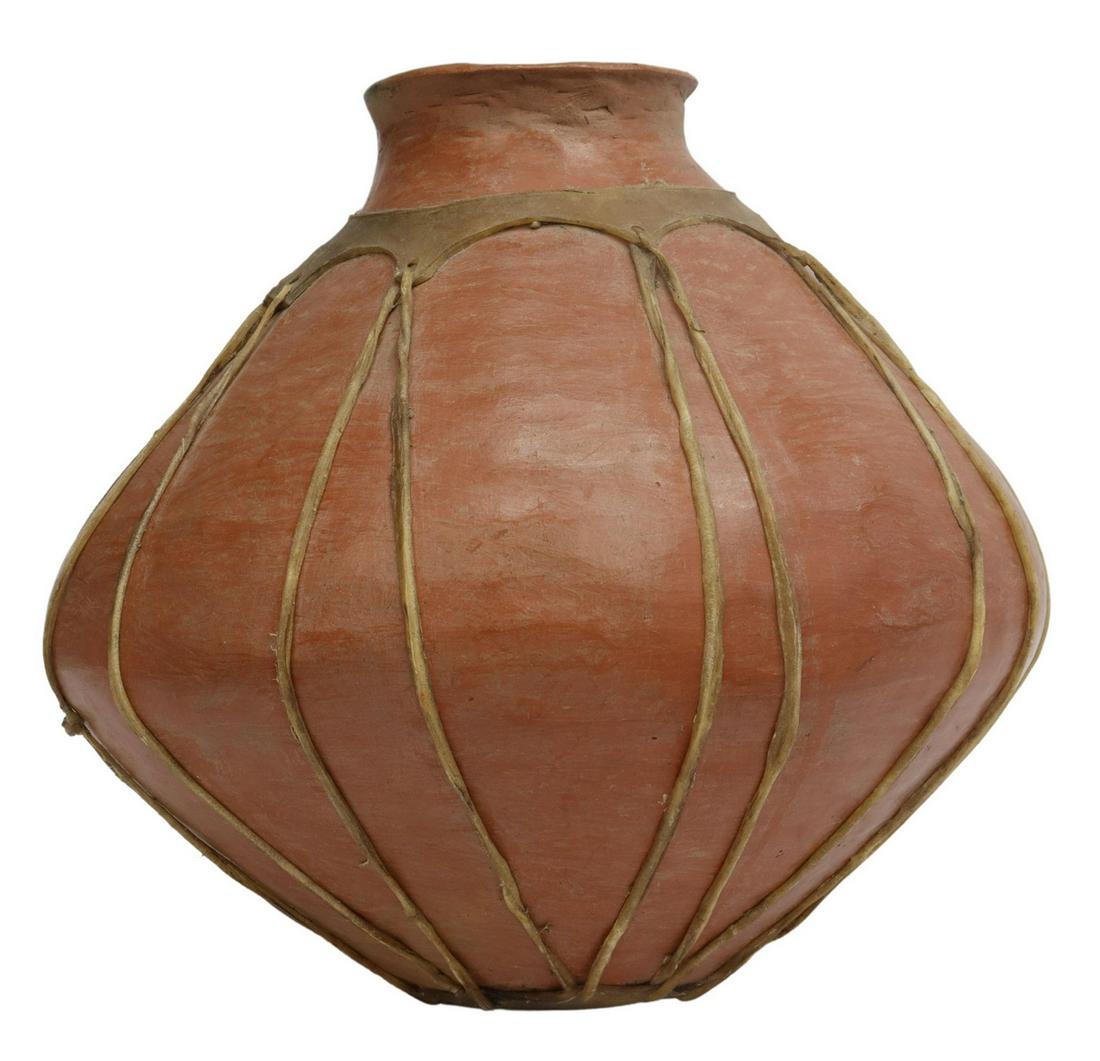 MEXICAN TARAHUMARA TERRACOTTA OLLA VESSEL: Mexican terracotta olla vessel, Tarahumara people, with rawhide lacing to exterior, approx 15"h, 16"diam, 10.8lbs Start Price: $50.00