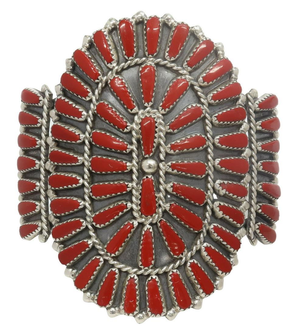 SAMMIE BYJOE NAVAJO STERLING & RED CORAL CUFF: Native American sterling silver cuff bracelet, signed S, (Sammie Byjoe, Navajo, 20thc.) radiating clusters of red coral set within serrated bezels, on a split shank cuff, central plaque: approx 2.75"h