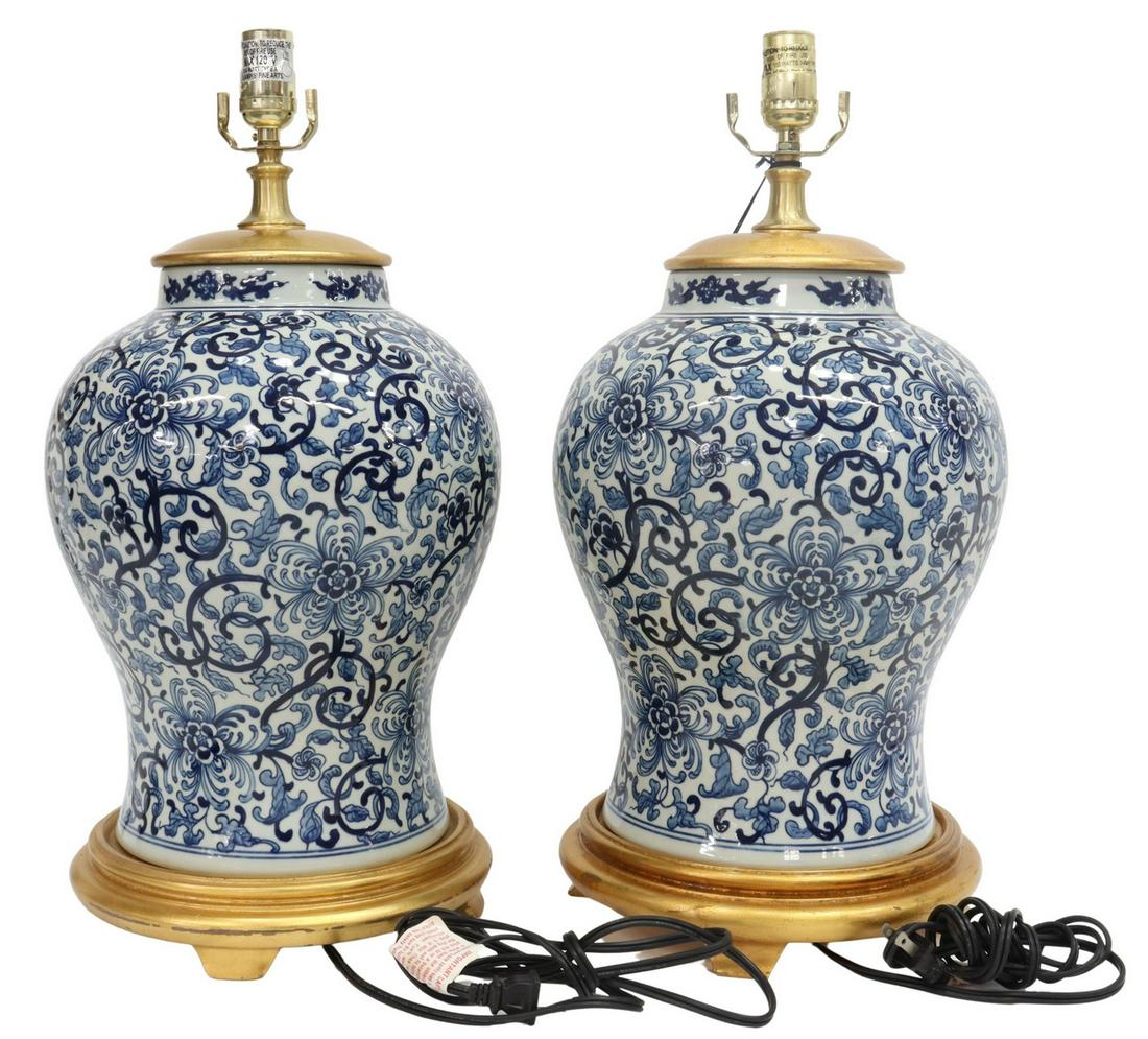 (2) RALPH LAUREN CHINESE B&W PORCELAIN TABLE LAMPS: (pair) Chinoiserie single-light table lamps, Ralph Lauren Home, 21st c., blue and white porcelain vase, with floral scroll design, mounted with a giltwood cap and base, some wear to gilding, approx 21