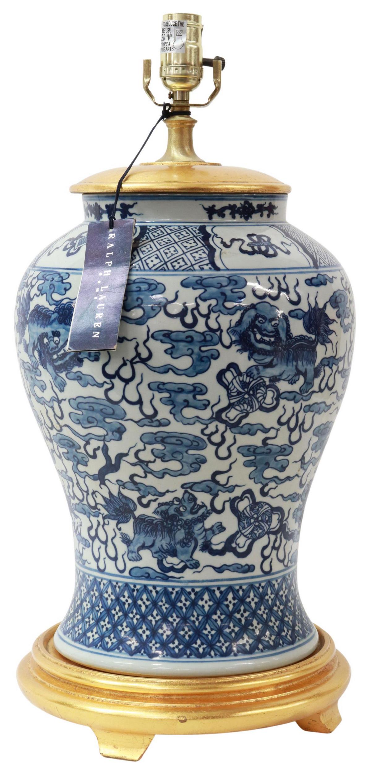 RALPH LAUREN CHINESE B&W PORCELAIN TABLE LAMP: Chinoiserie single-light table lamp, Ralph Lauren Home, 21st c., blue and white porcelain vase, with foo lions surrounded by stylized clouds, mounted with a giltwood cap and base, approx 22.25"h, 11"d