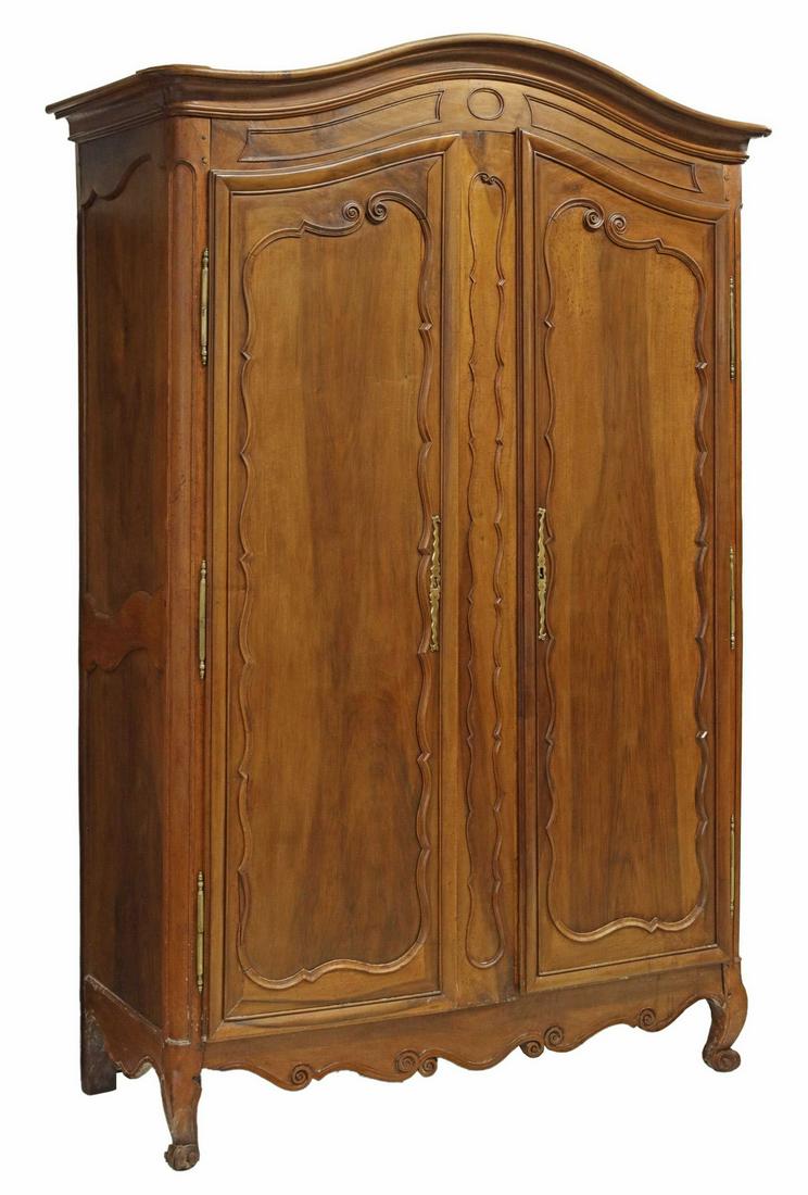 FRENCH PROVINCIAL LOUIS XV STYLE WALNUT ARMOIRE: French Provincial Louis XV style walnut armoire, 19th c., arched cornice, two scroll paneled doors on exterior hinges, interior shelves, scrolled apron, rising on cabriole legs, ending in whorl feet, 