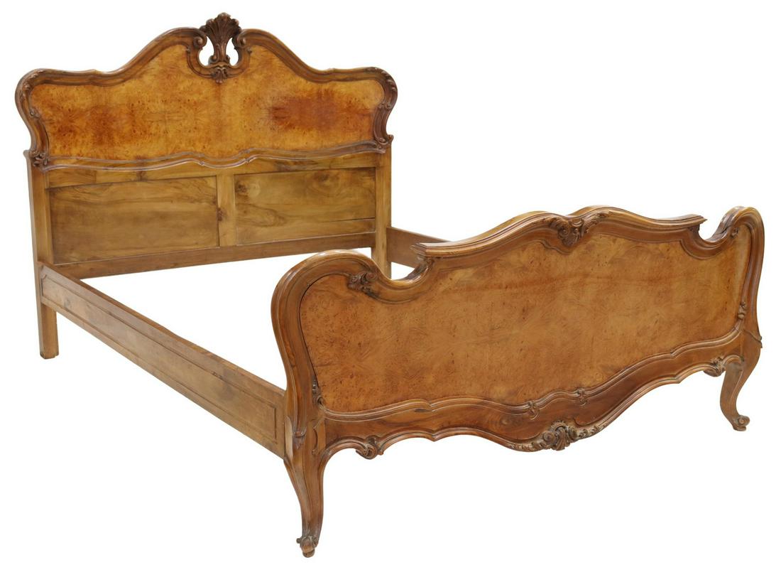 LOUIS XV STYLE CARVED WALNUT QUEEN SIZE BED: Louis XV style walnut queen size bed, 20th c., having carved rocaille detailing to frame and crest, rising on cabriole legs, terminating in scrolled feet, exterior: approx 51.5"h, 83"l, 62.75"w, inter