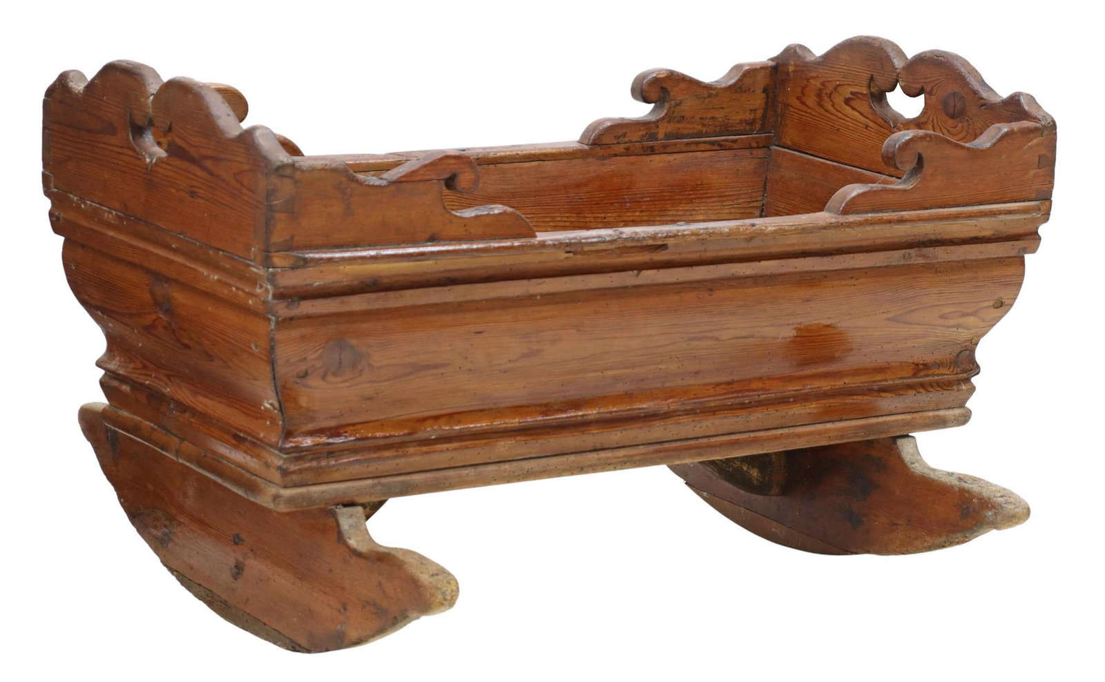 ANTIQUE SWEDISH PINE ROCKING BASSINET CRADLE: Swedish pine bassinet/ cradle, 19th c., with shaped rails, dovetailed and pegged construction, on rockers, approx 21.25"h, 35.25"l, 29"w **Note: for decorative use only** Start Price: $80.00