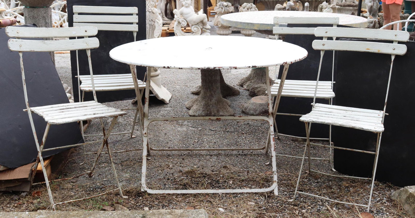 (5) FRENCH IRON BISTRO SET W/ TABLE & CHAIRS: (lot of 5) French iron bistro set, including: (1) white round top table, with hole to accommodate an umbrella, rising on cross stretcher-joined base, approx 28"h, 40.25"diam; (4) folding bistro/ garde