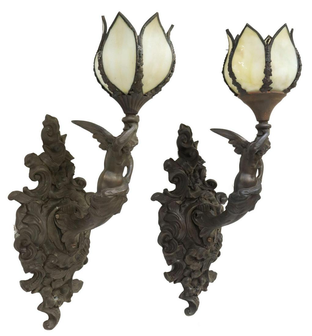 (2) LOEVSKY VICTORIAN STYLE SLAG GLASS SCONCES: (pair) American Victorian style cast metal wall sconces, Loevsky and Loevsky, 20th c., floriform shade with slag glass petals, concealing a single light, supported by a winged female caryatid, issuing