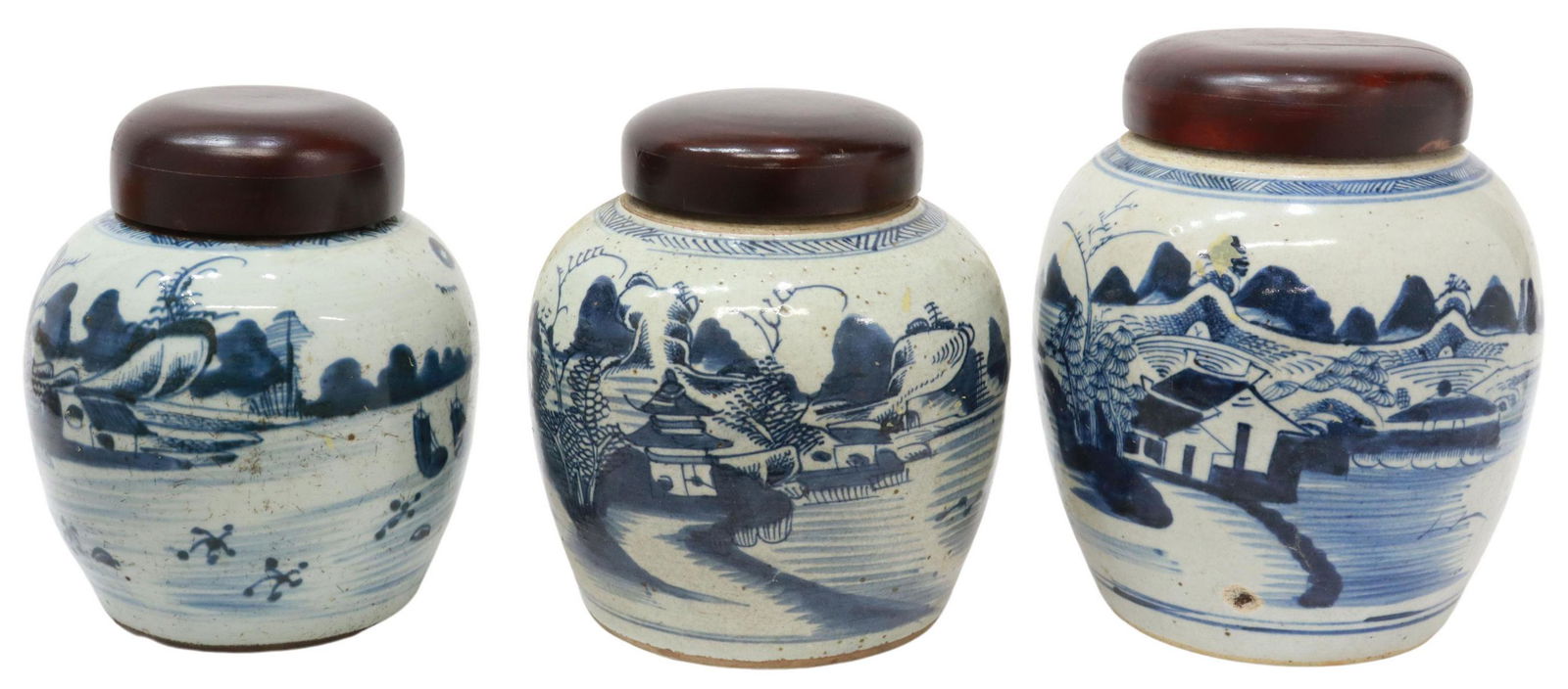 (3) CHINESE CANTON BLUE & WHITE PORCELAIN JARS: (lot of 3) Chinese Canton style blue and white porcelain ginger jars, with loosely painted water landscapes, wood lids, glaze pitting, medium example with small chip to rim, large example with flaw to