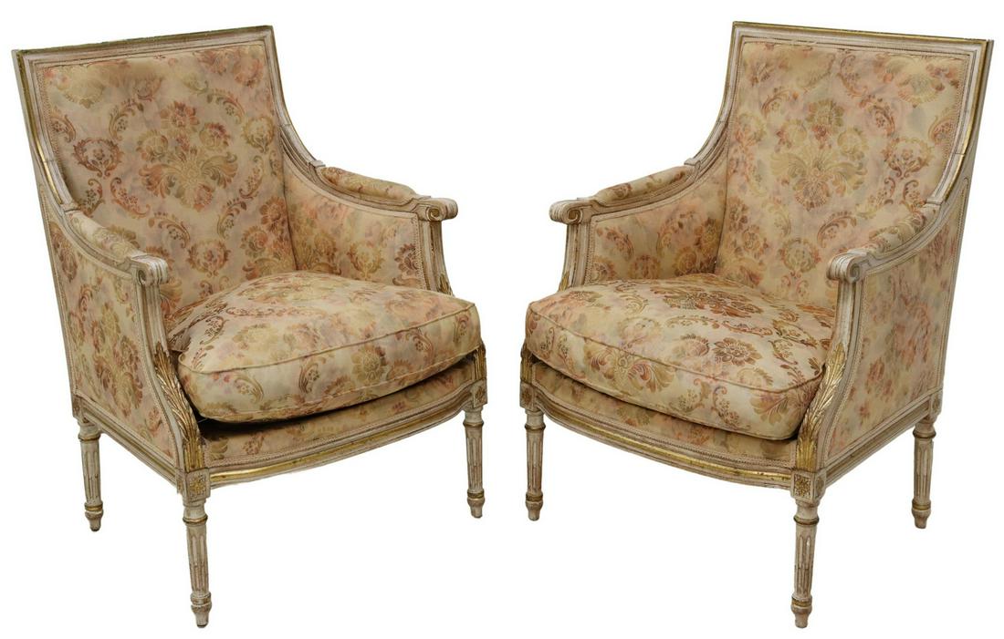 (2) FRENCH LOUIS XVI STYLE PARCEL GILT BERGERES: (pair) French Louis XVI style armchairs, having scrolling armrests, back and seat upholstered in floral motif, rising on tapered fluted legs, approx 38"h, 26"w, 18.5"d, seat height: 21"h Start Price: 