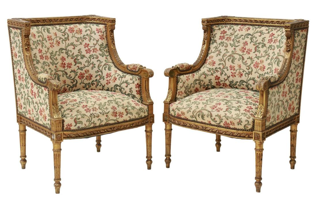 (2) FRENCH LOUIS XVI STYLE GILTWOOD BERGERES: (pair) French Louis XVI style giltwood armchairs, late 19th c., frame with beaded and foliate molding, upholstered back and seat, closed arms, acanthus scroll handholds, rising on tapered fluted legs,