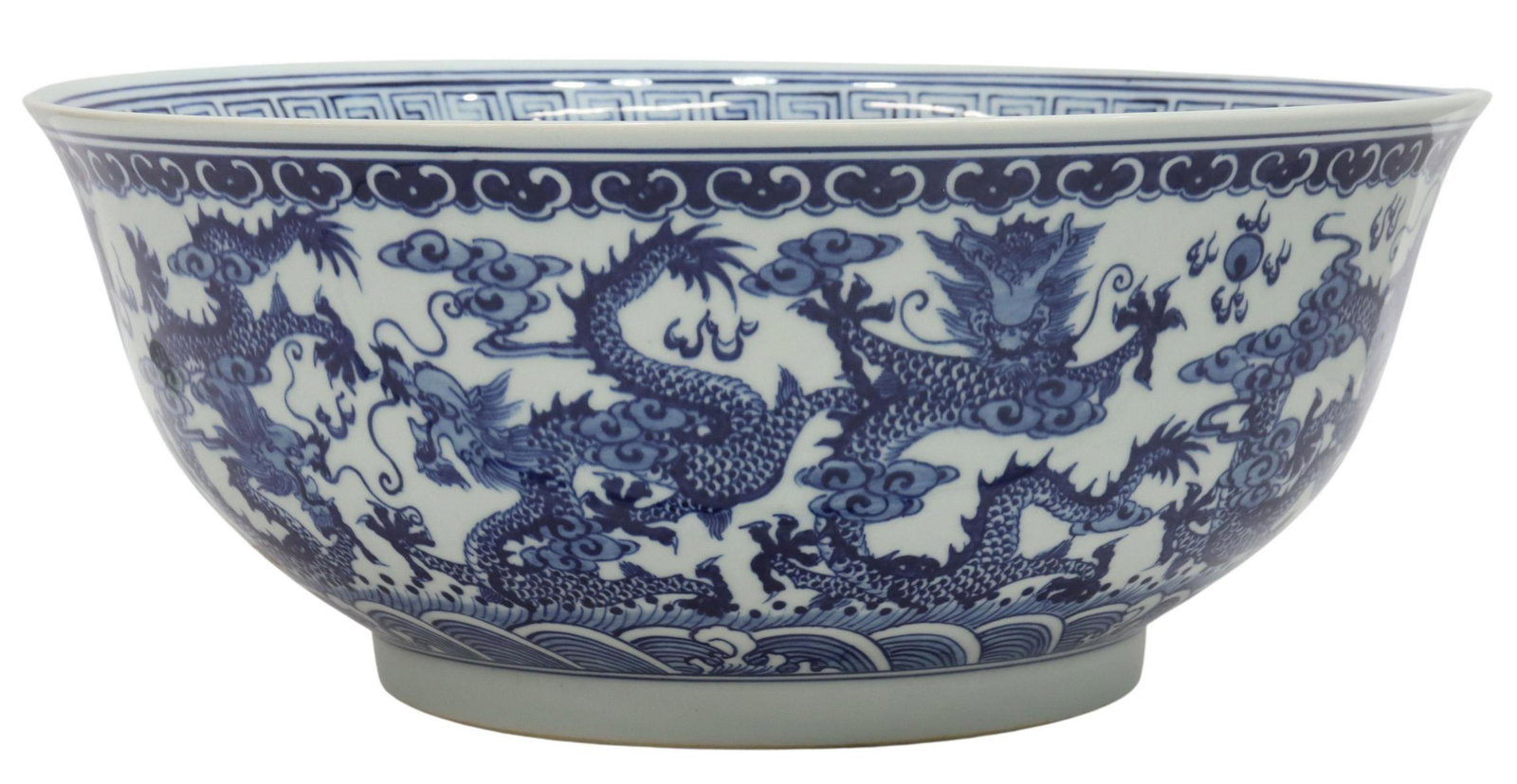 CHINESE BLUE & WHITE PORCELAIN CENTER BOWL: Large Chinese blue and white porcelain center bowl, late 20th c., with Greek key border, dragons chasing flaming pearls, surrounded by stylized clouds, waves, approx 6.5"h, 15.75"diam, 10lbs Start Pri