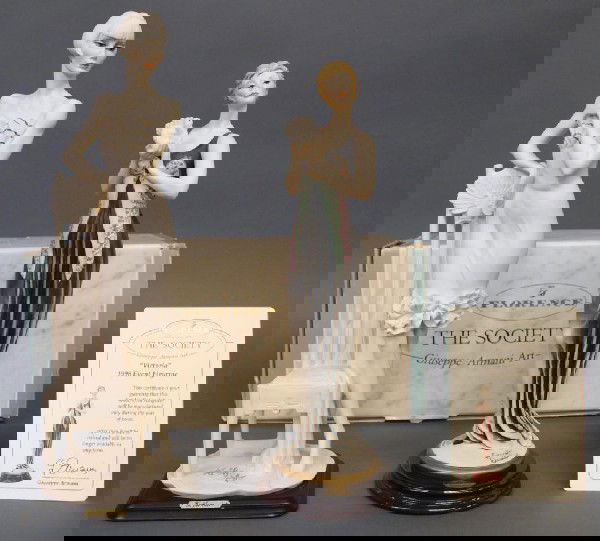 GIUSEPPE ARMANI FIGURES, VICTORIA & ART DECO LADY: (lot of 2) Giuseppe Armani figures: (1) 'Victoria', 'The Society Event Figure, 1998', 14.5"h, retaining papers and box: 6"h, 16"l, 7.5"w; (1) Etrusca Arte Armani Deco style lady peacock, dated 1990, 1