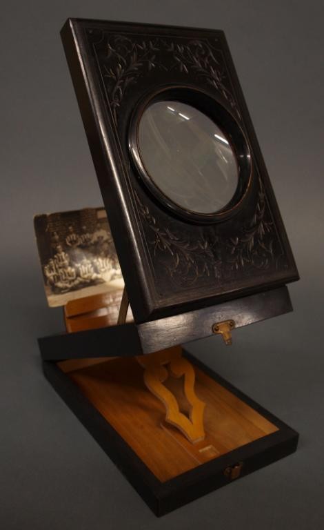 VICTORIAN INCISED EBONIZED PARLOR GRAPHOSCOPE: Victorian ebonized parlor graphoscope viewer, c. 1885, with incised foliate decoration, accompanied by (1) photo postcard showing the 'Smiths Football Club, France", closed: 2.5"h, 8.5"w, 5.5"d, 1.25l