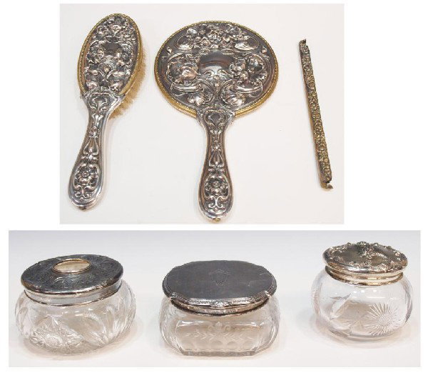AMERICAN STERLING SILVER REPOUSSE DRESSER SET: (lot of 6) American sterling and silver plate vanity articles including: (1) Mauser floral cut glass dresser jar , the stering silver lid centered by the form of a putti swinging from garland; (1) Gor